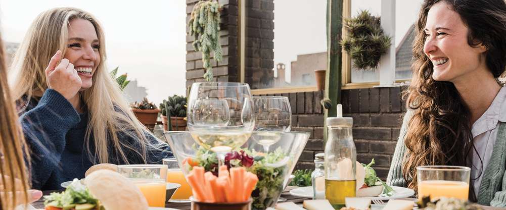 Two woman at a table with food