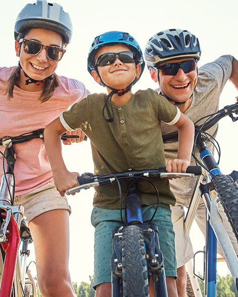 Family wearing bike helmets outdoors