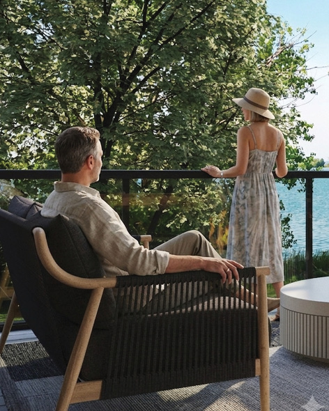 People relaxing outdoors near water under trees